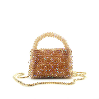beige beaded handbag with gold chain. on white background