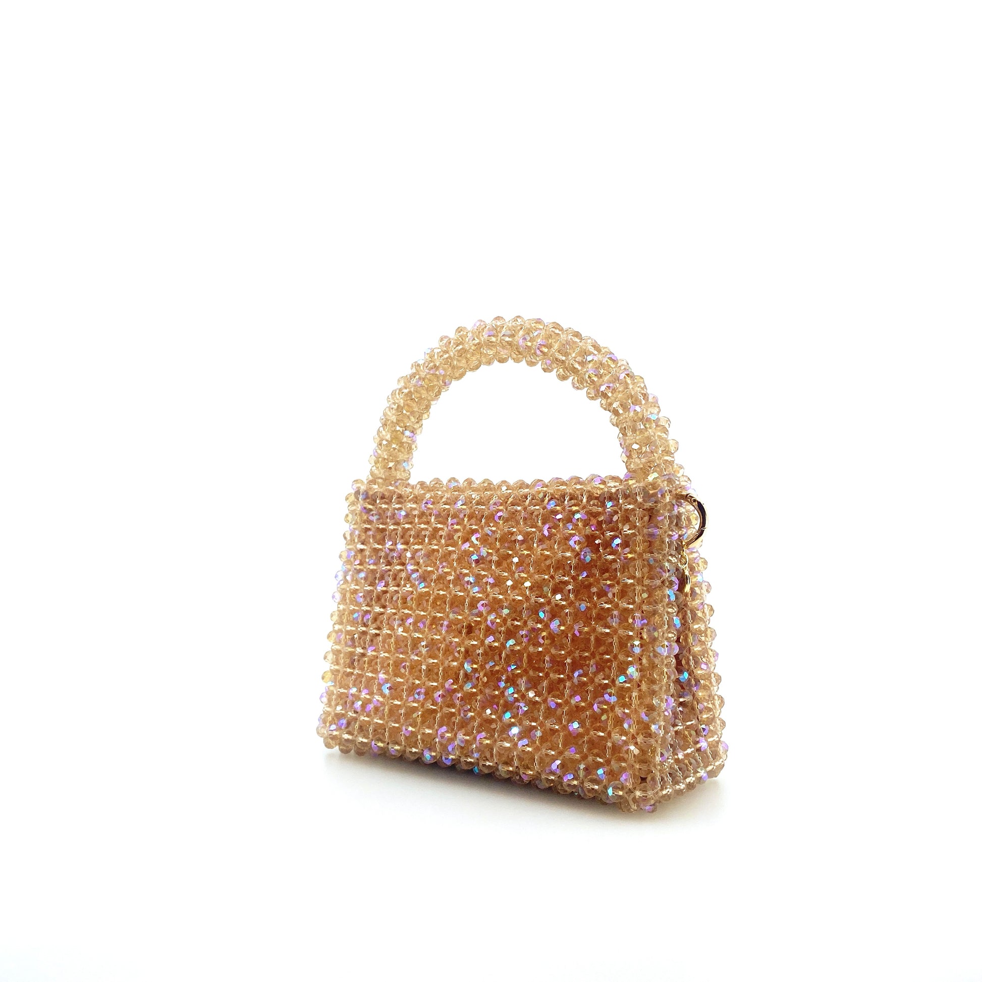 beige beaded handbag. on white background