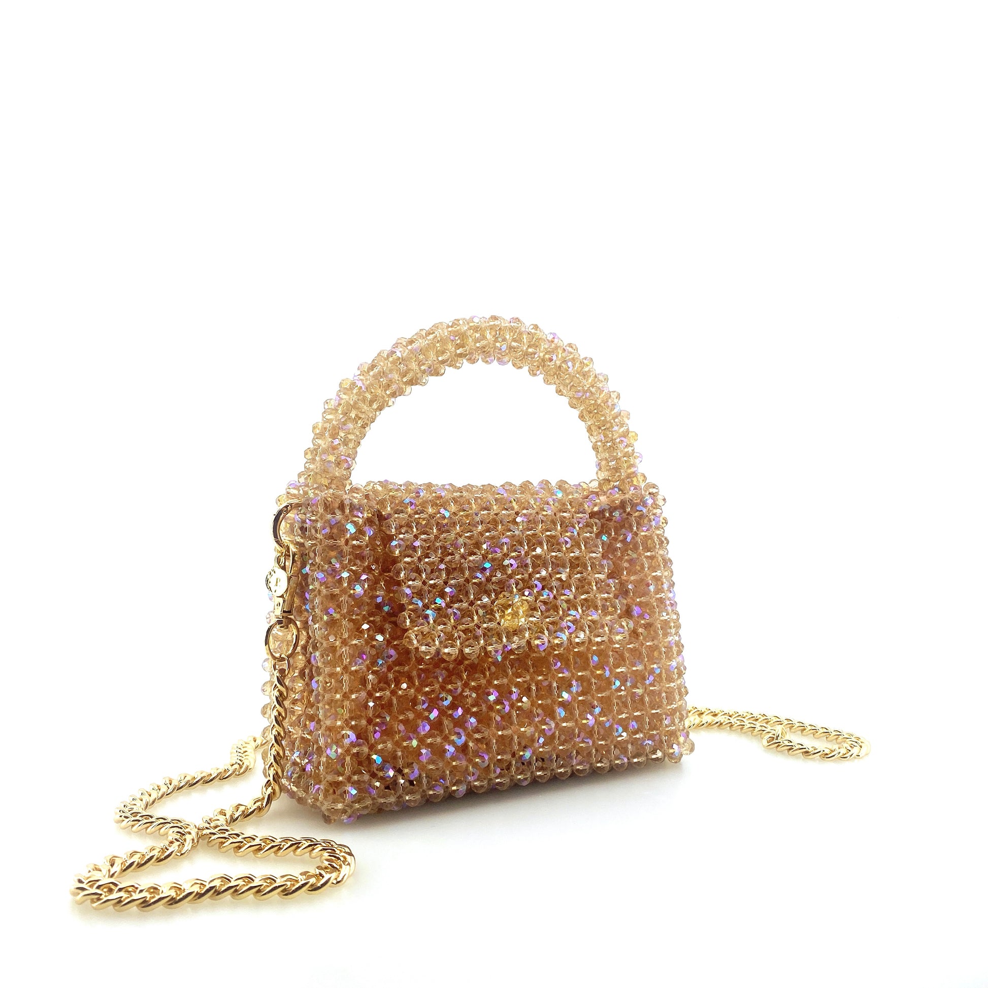 beige beaded handbag with gold chain. on white background