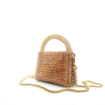 beige beaded handbag with gold chain. on white background