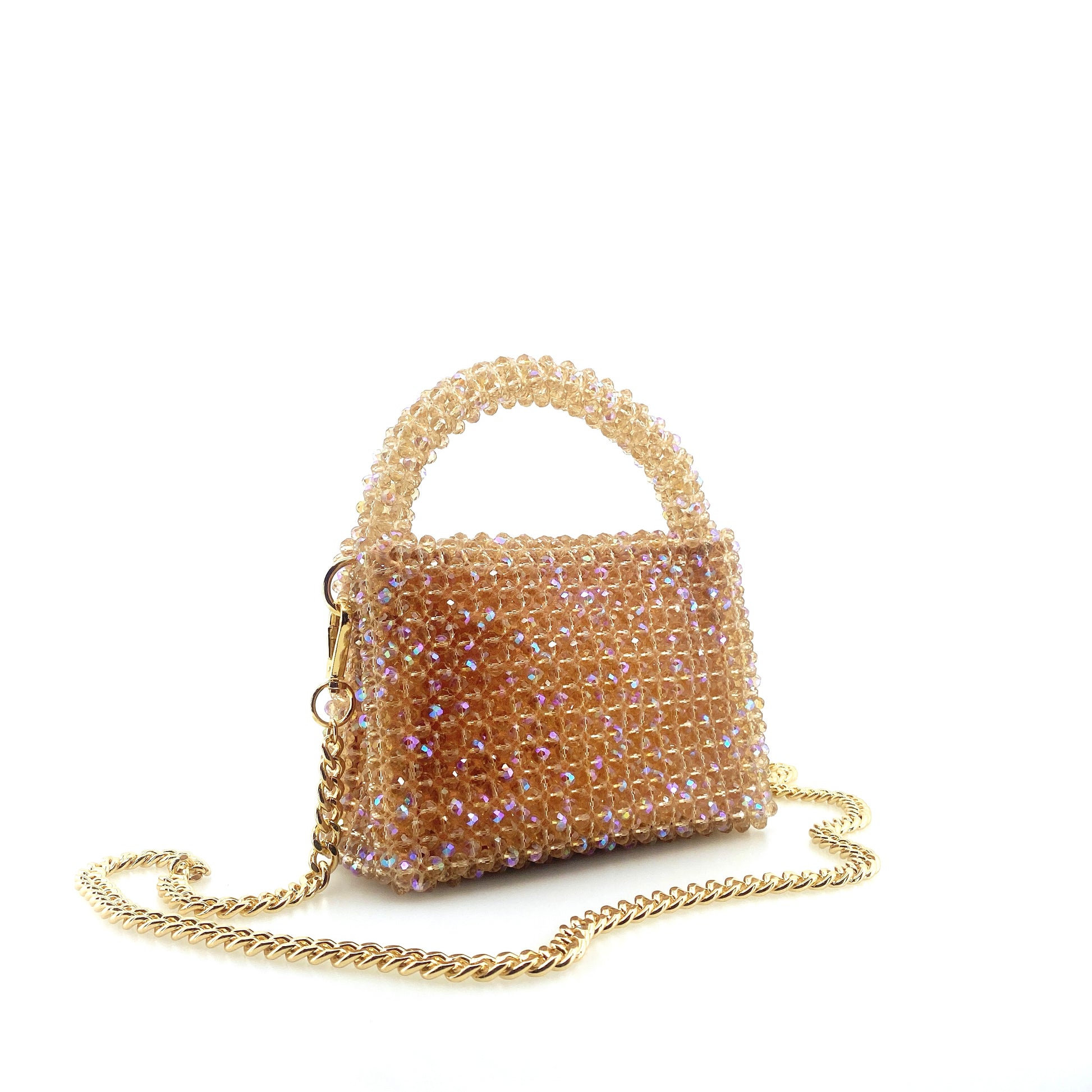 beige beaded handbag with gold chain. on white background