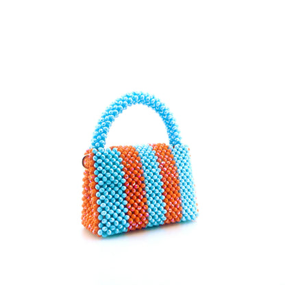 blue and orange stripe beaded handbag. on white background