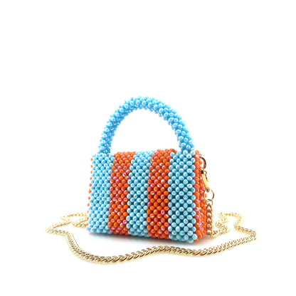blue and orange stripe beaded handbag with gold chain. on white background
