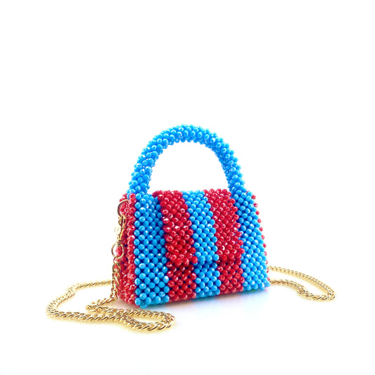 blue and red stripe beaded handbag with gold chain. on white background