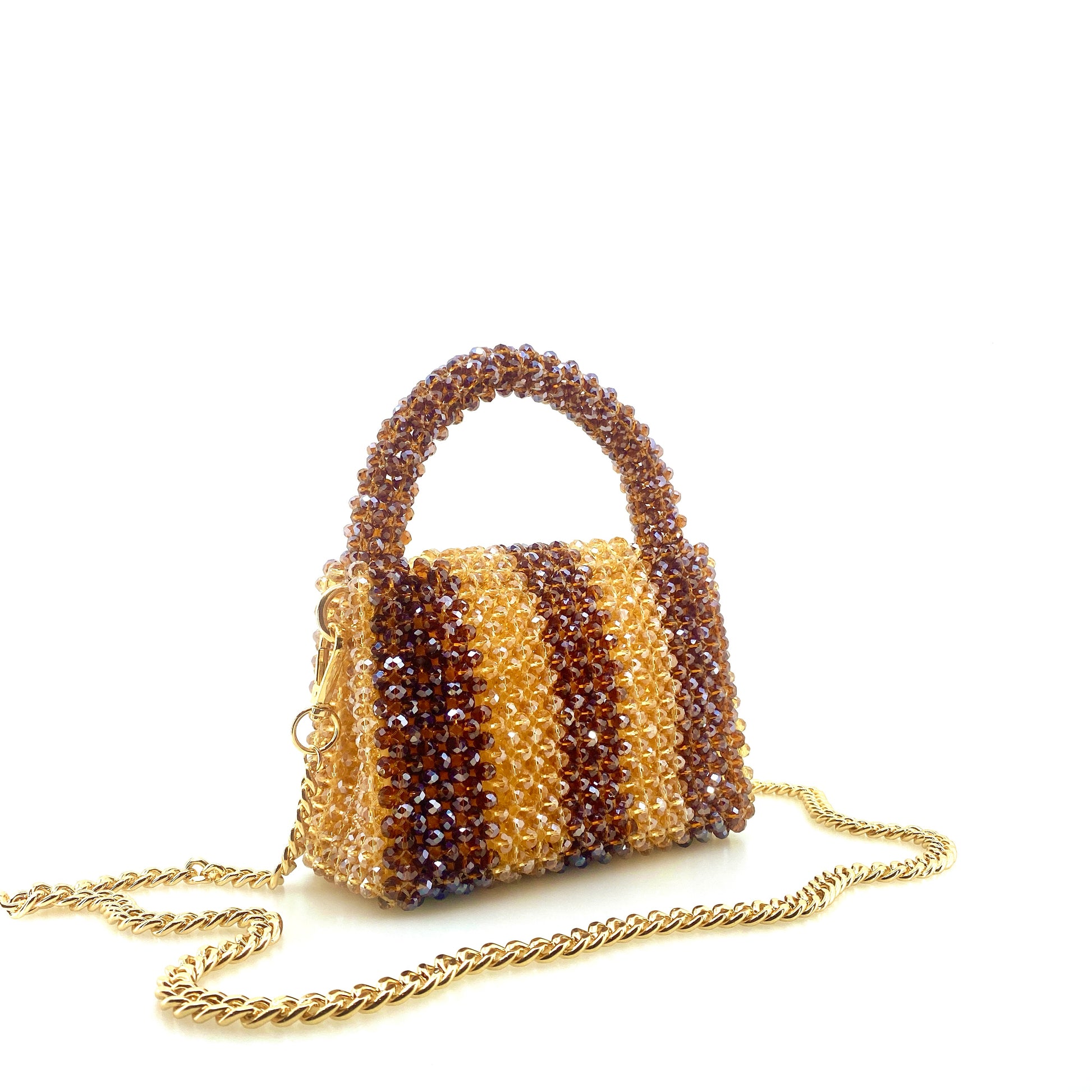 brown and beige stripe beaded handbag with gold chain. on white background