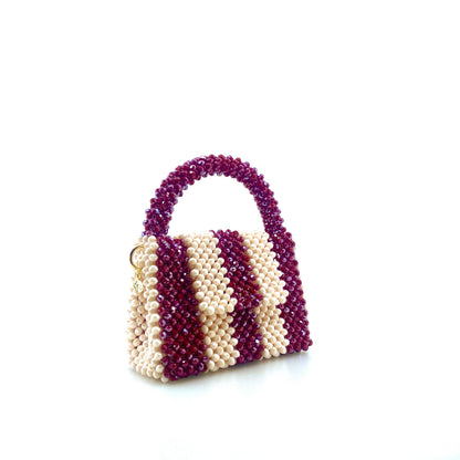 burgundy and cream stripe beaded handbag. on white background