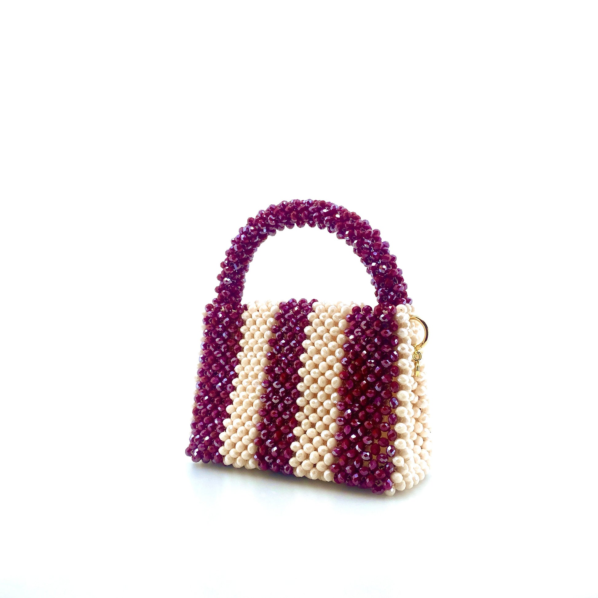 burgundy and cream stripe beaded handbag. on white background