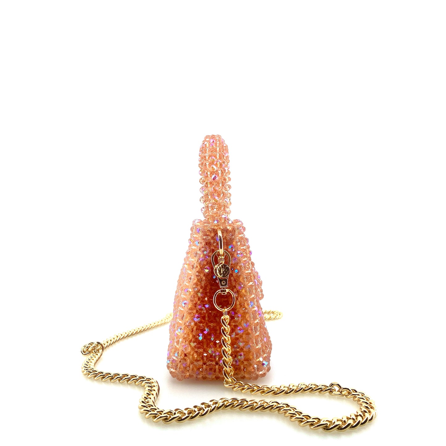 coral pink beaded handbag with gold chain. on white background 