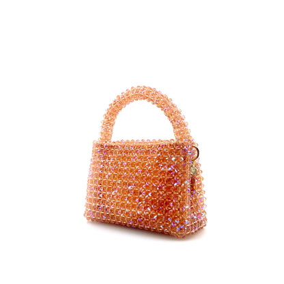 coral pink beaded handbag. on white background 