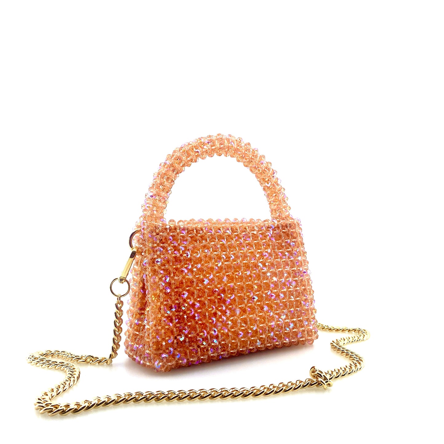 coral pink beaded handbag with gold chain. on white background 