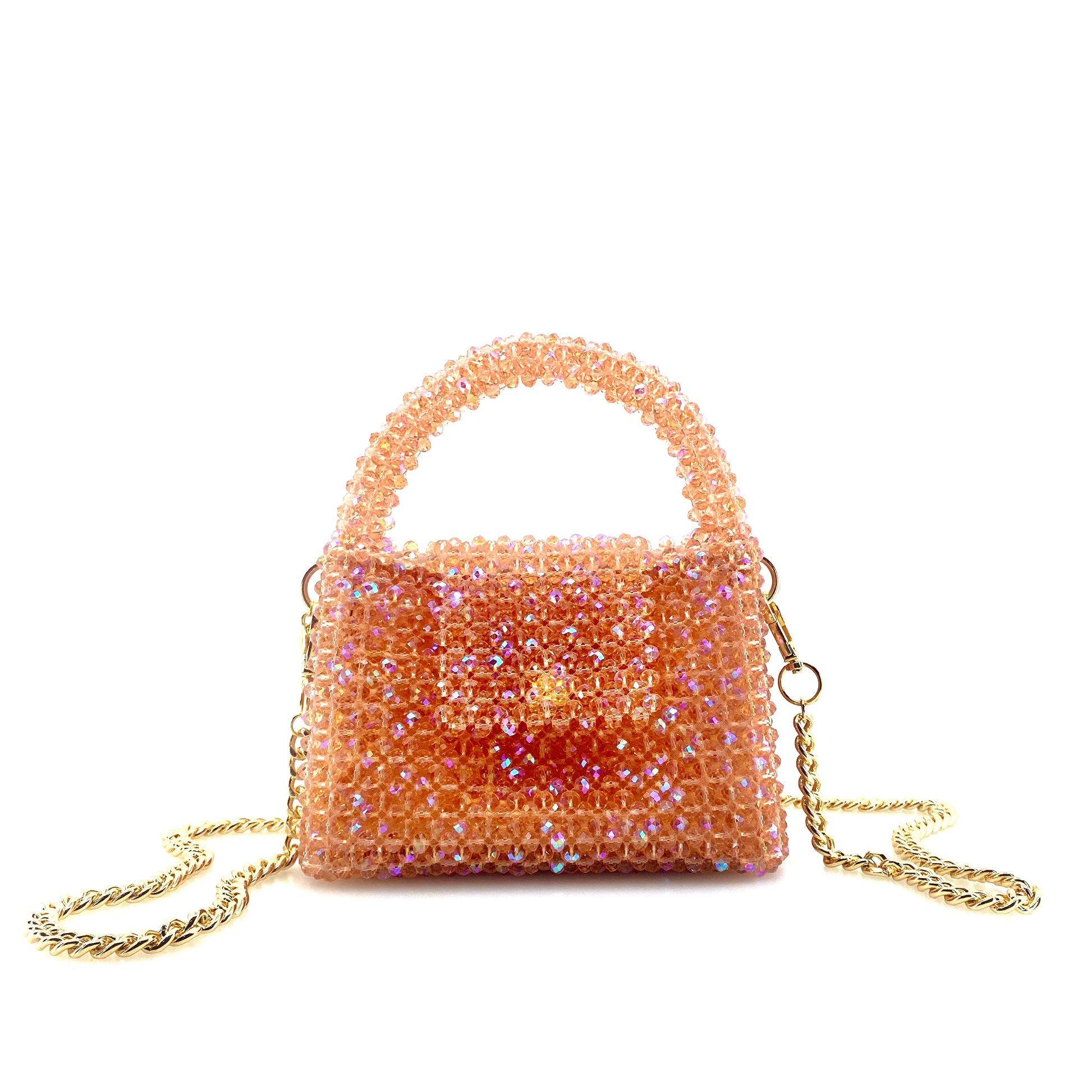 coral pink beaded handbag with gold chain. on white background 