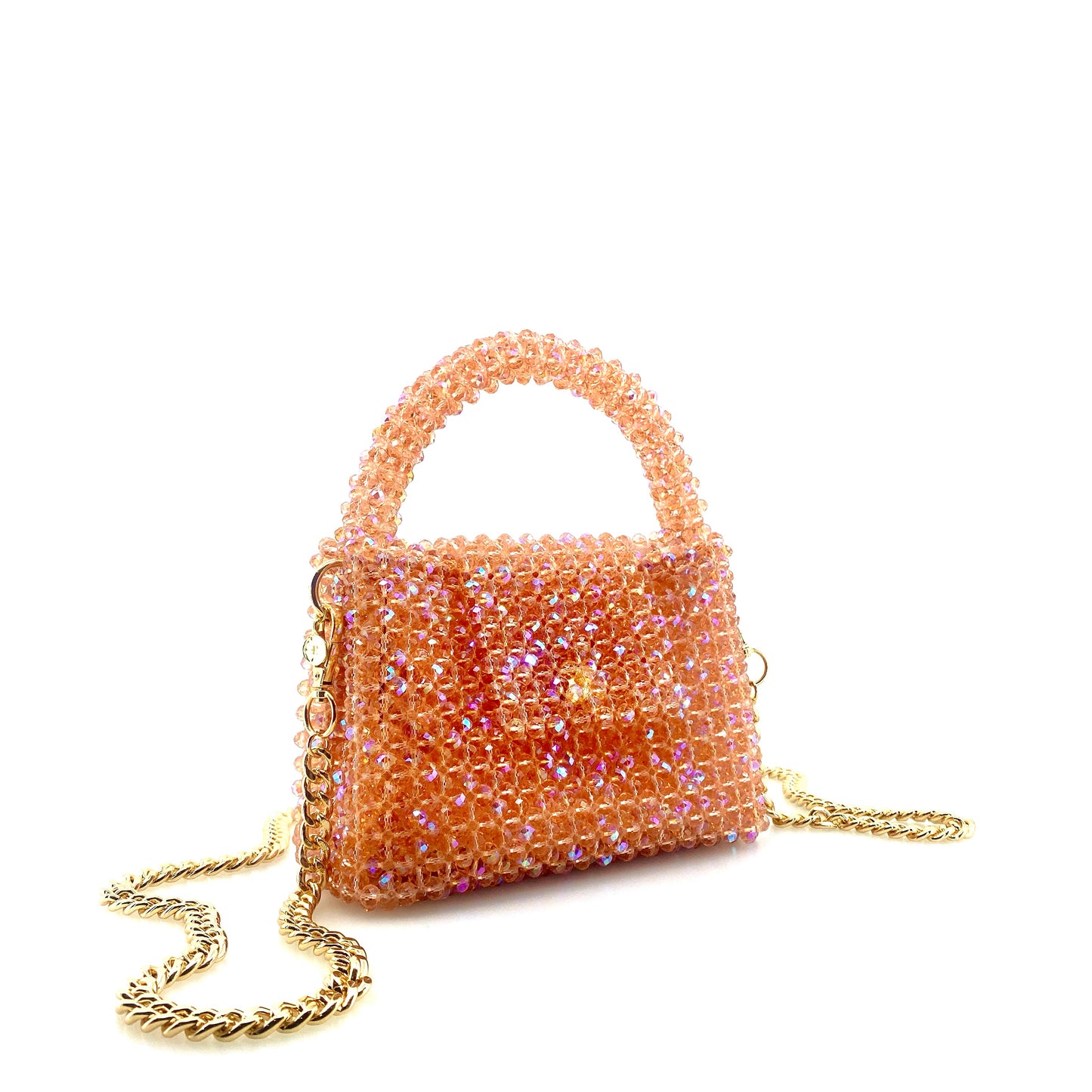 coral pink beaded handbag with gold chain. on white background 