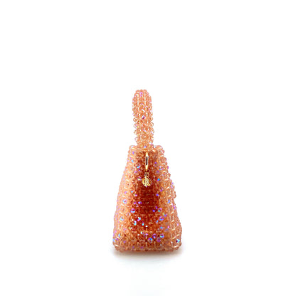 coral pink beaded handbag. on white background 