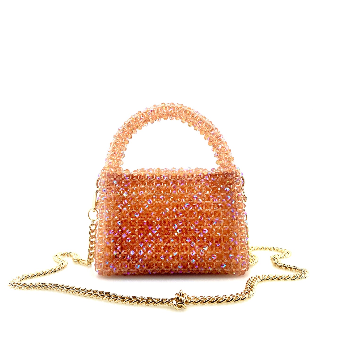 coral pink beaded handbag with gold chain. on white background 