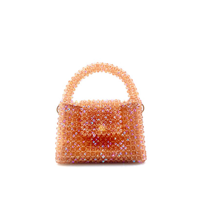 coral pink beaded handbag. on white background 