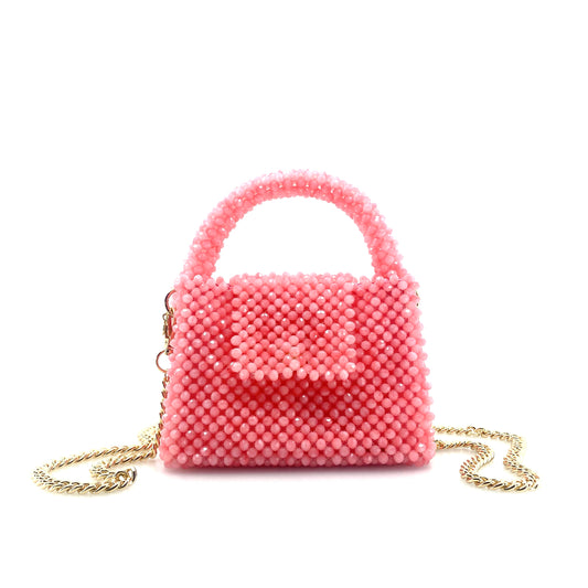 pink beaded handbag with gold chain. on white background