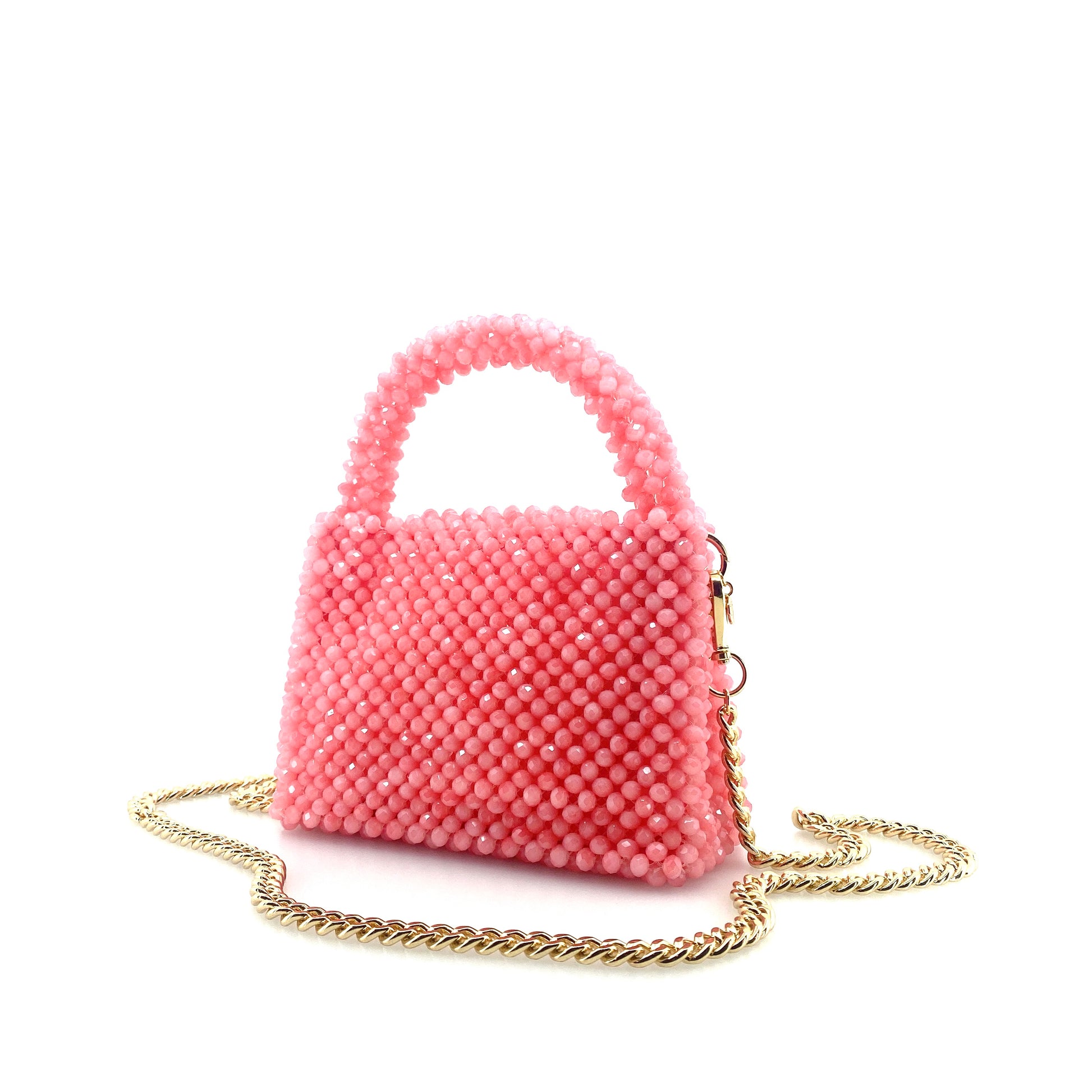 pink beaded handbag with gold chain. on white background