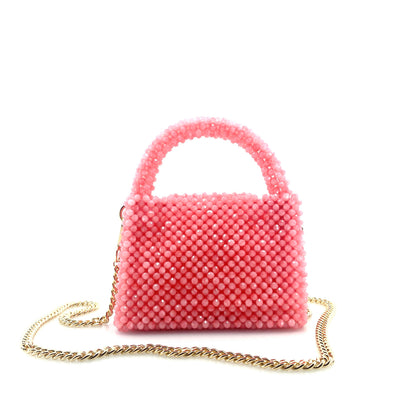 pink beaded handbag with gold chain. on white background