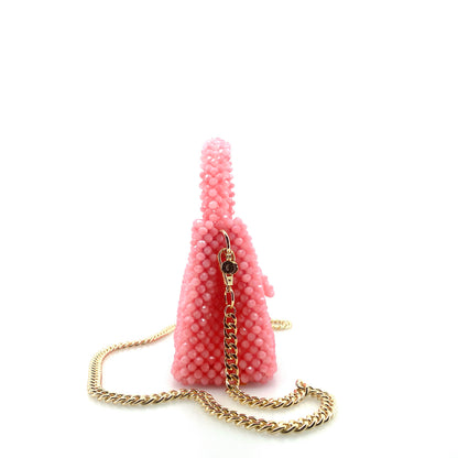 pink beaded handbag with gold chain. on white background