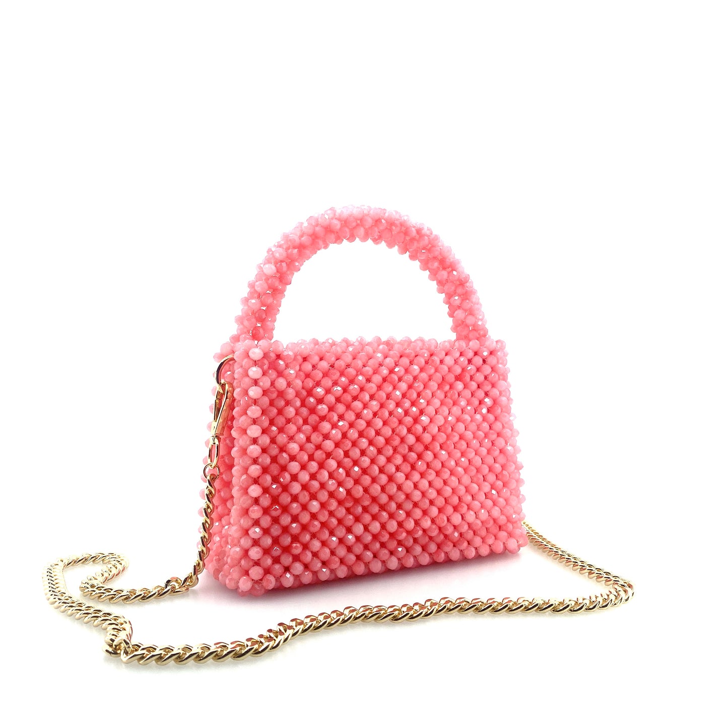 pink beaded handbag with gold chain. on white background