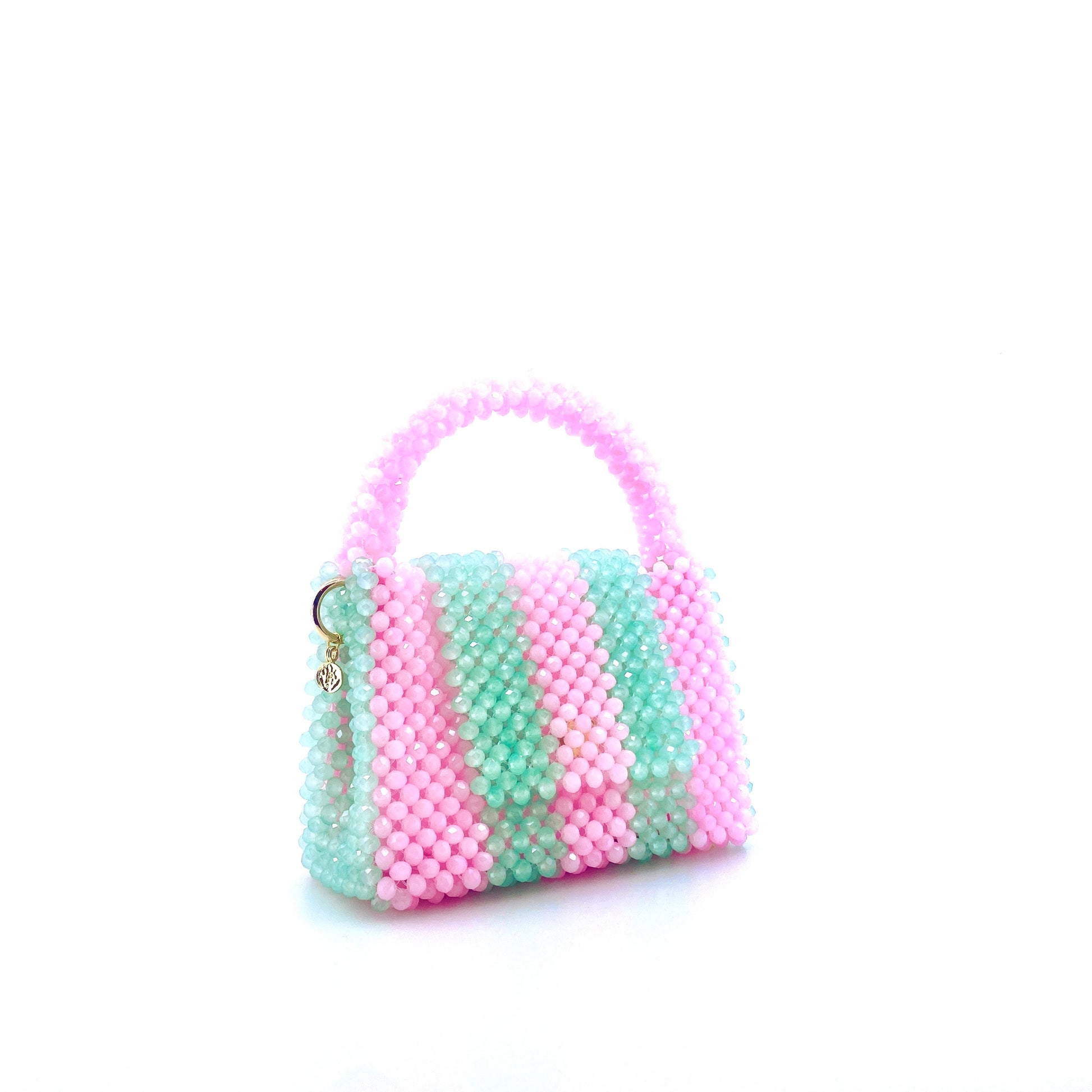 green and pink stripe beaded handbag. on white background