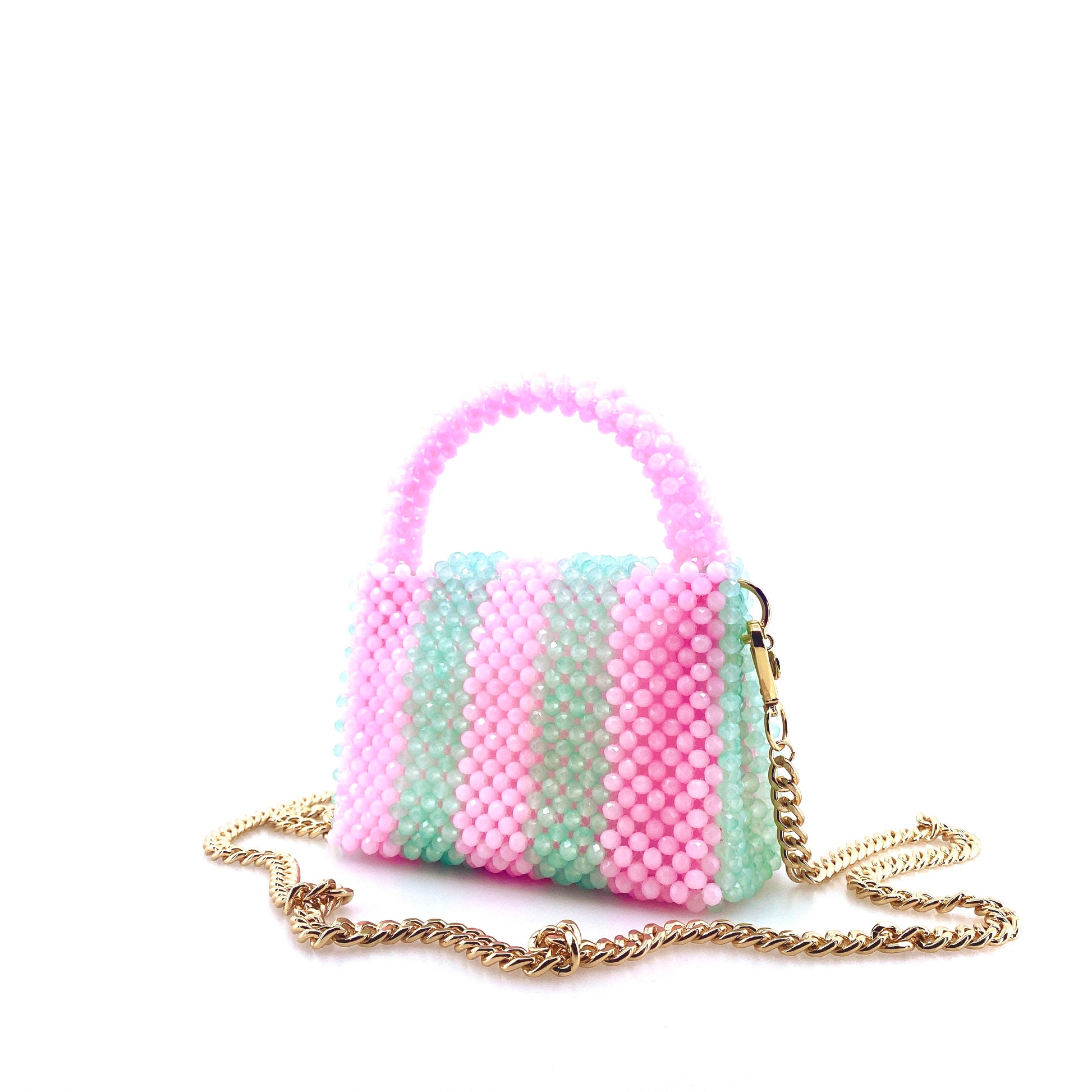 green and pink stripe beaded handbag with gold chain. on white background