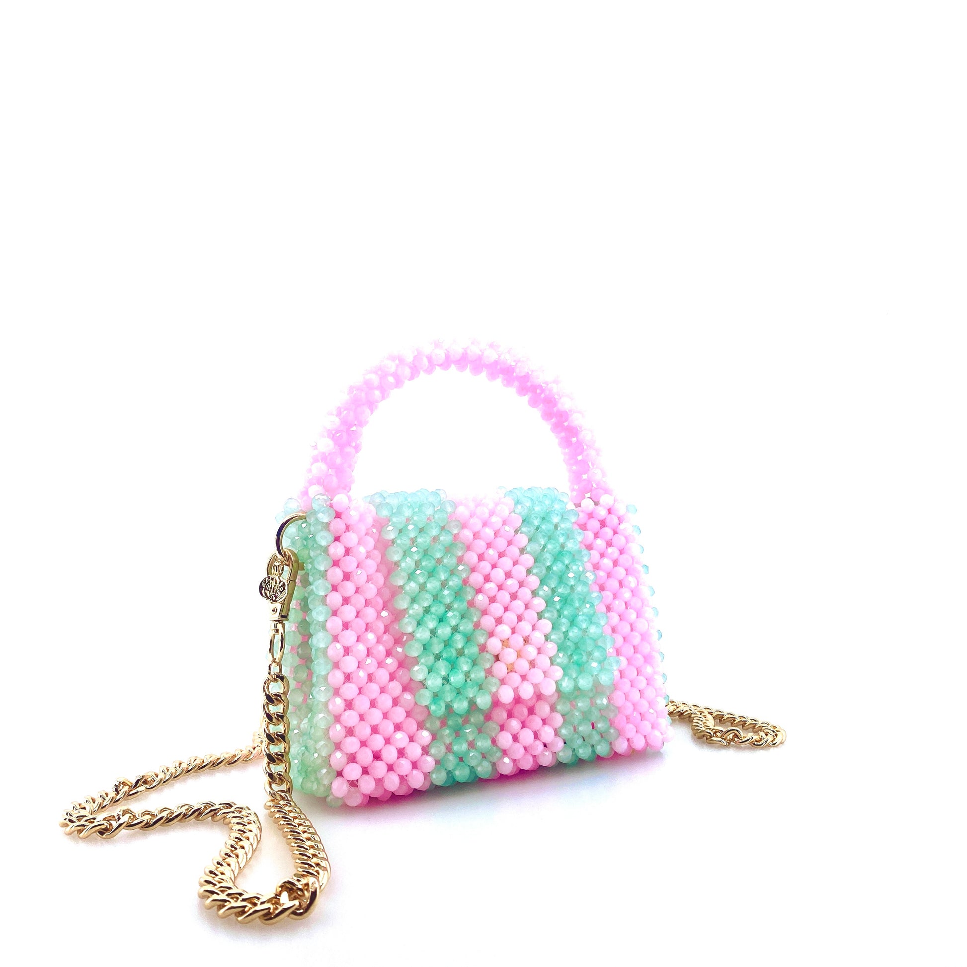 green and pink stripe beaded handbag with gold chain. on white background