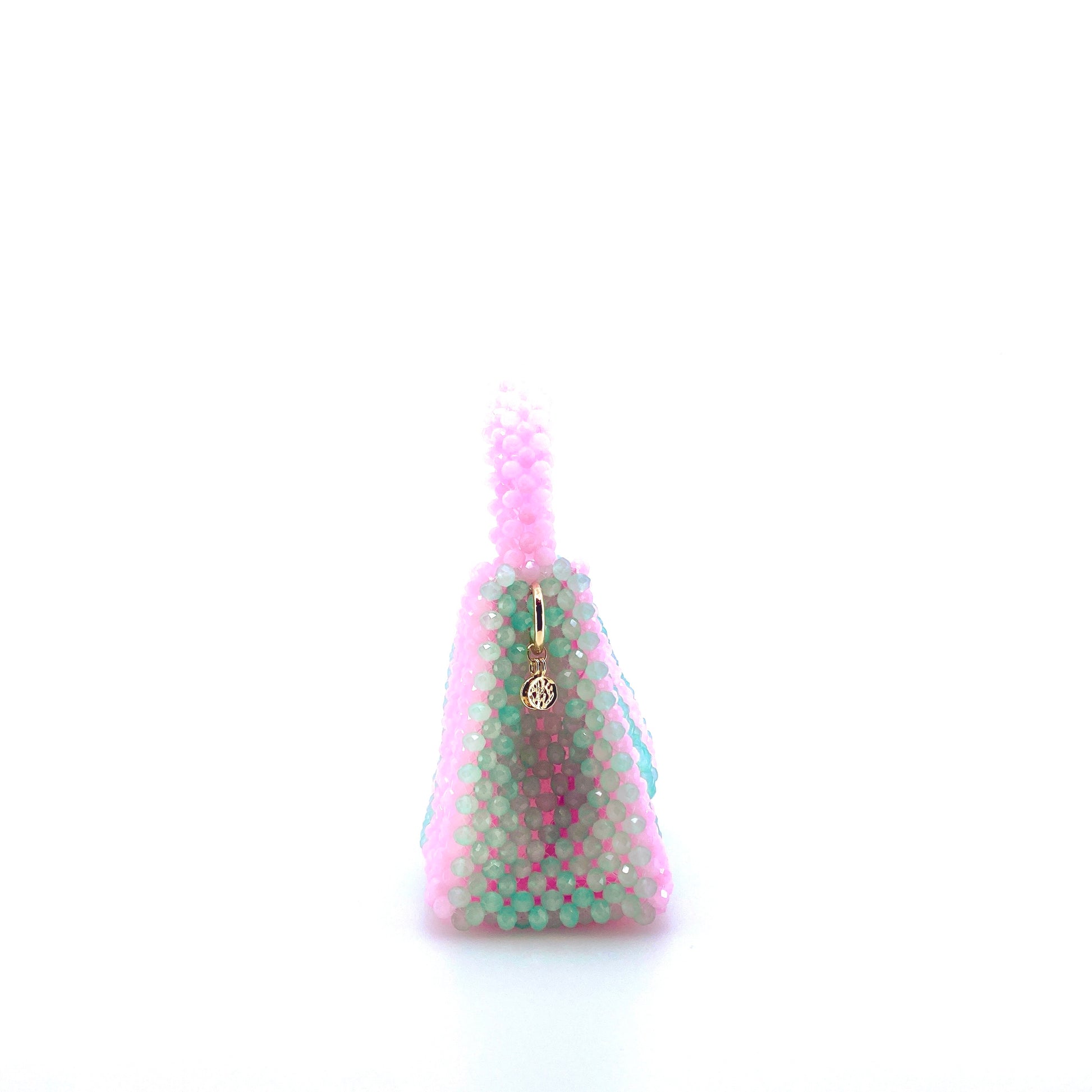 green and pink stripe beaded handbag. on white background