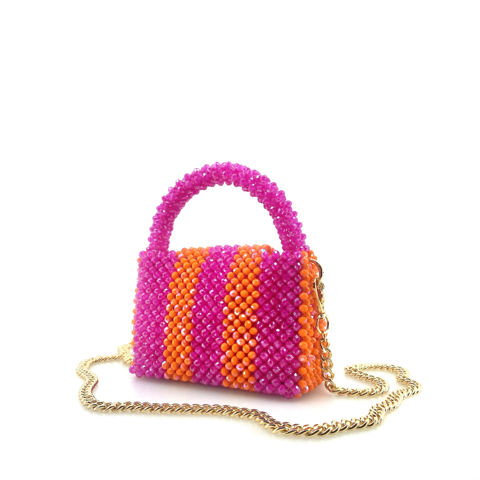 pink and orange stripe beaded handbag with gold chain. on white background