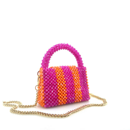 pink and orange stripe beaded handbag with gold chain. on white background