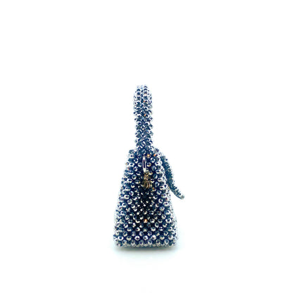 silver beaded handbag on white background