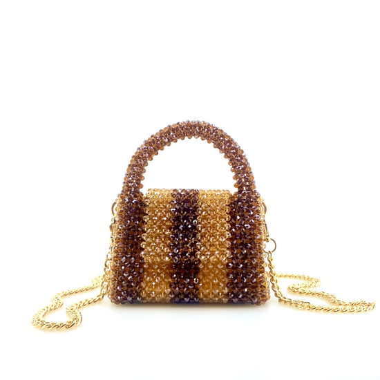 rotating image of brown and beige stripe beaded handbag with gold chain. on white background