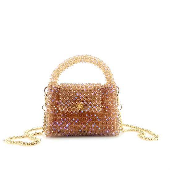 rotating image of beige beaded handbag with gold chain. on white background