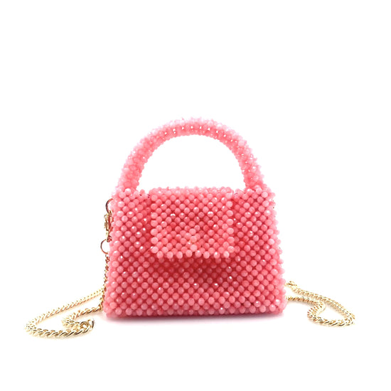 rotating image of pink beaded handbag with gold chain. on white background
